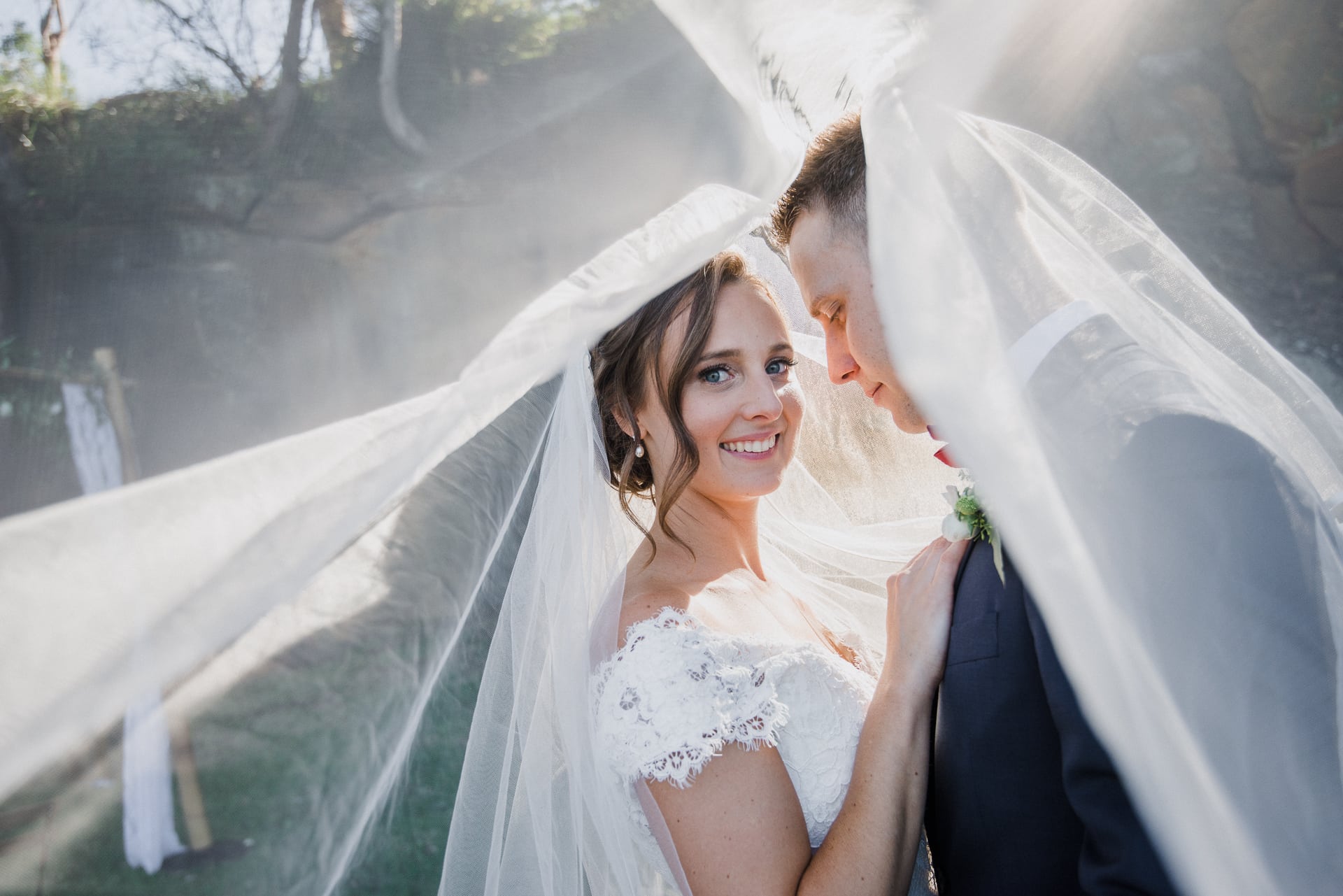 bride portrait smiling through wedding veil
