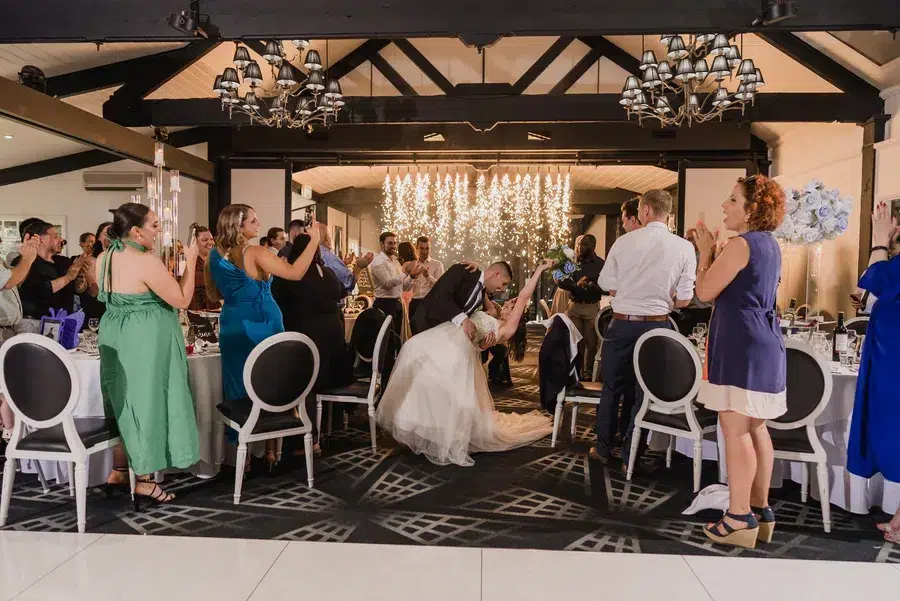 Bride-and-groom-dancing-with-guests-applauding.