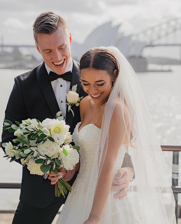 Bride and groom laughing at Royal Botanic Garden with Sydney Opera House in background