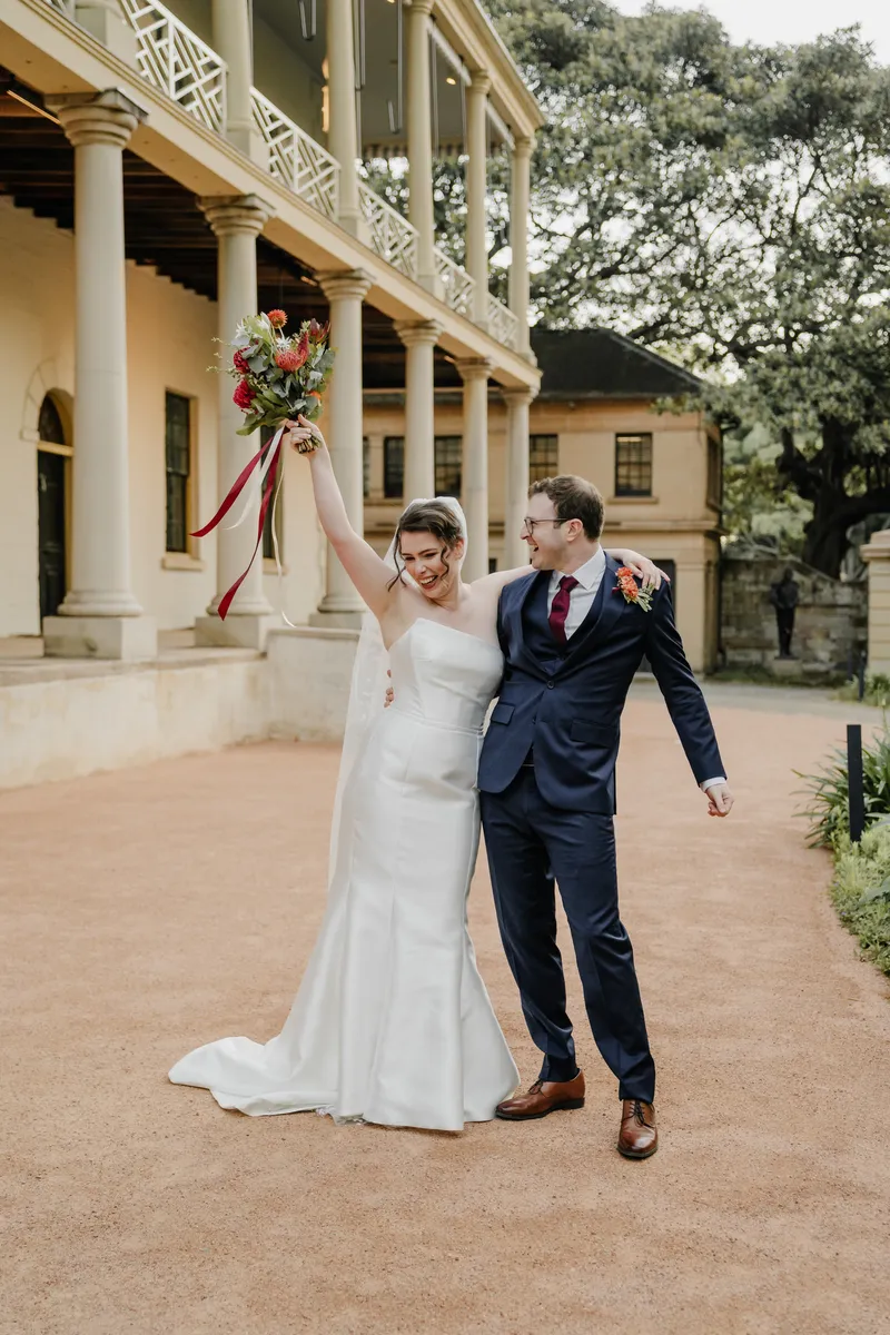 Bride and groom walking hand in hand at Sydney wedding venue The Mint