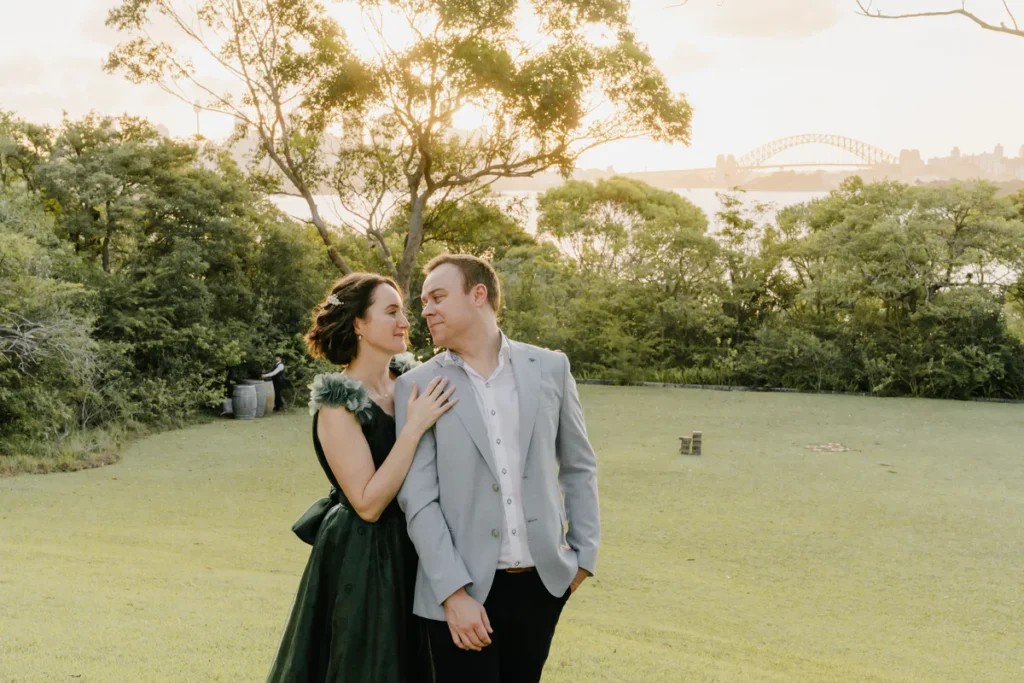 Couple portrait on the lawn at Athol Hall at sunset with Sydney Harbour Bridge in the background