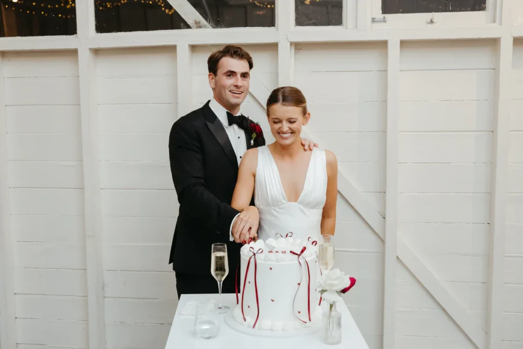 Bride and groom cutting the wedding cake at Athol Hall reception