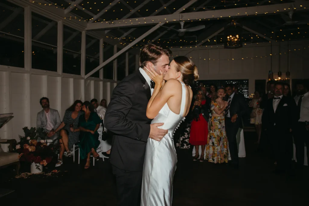 Bride and groom first dance inside Athol Hall wedding reception with fairy lights